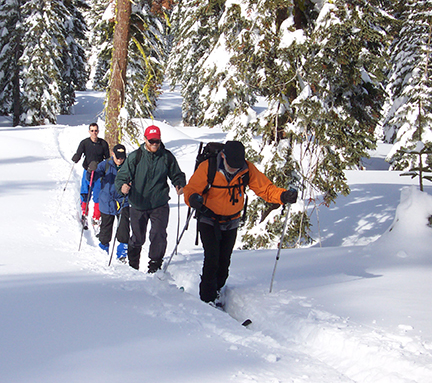 Image of skiers on ridge to Trail Junction